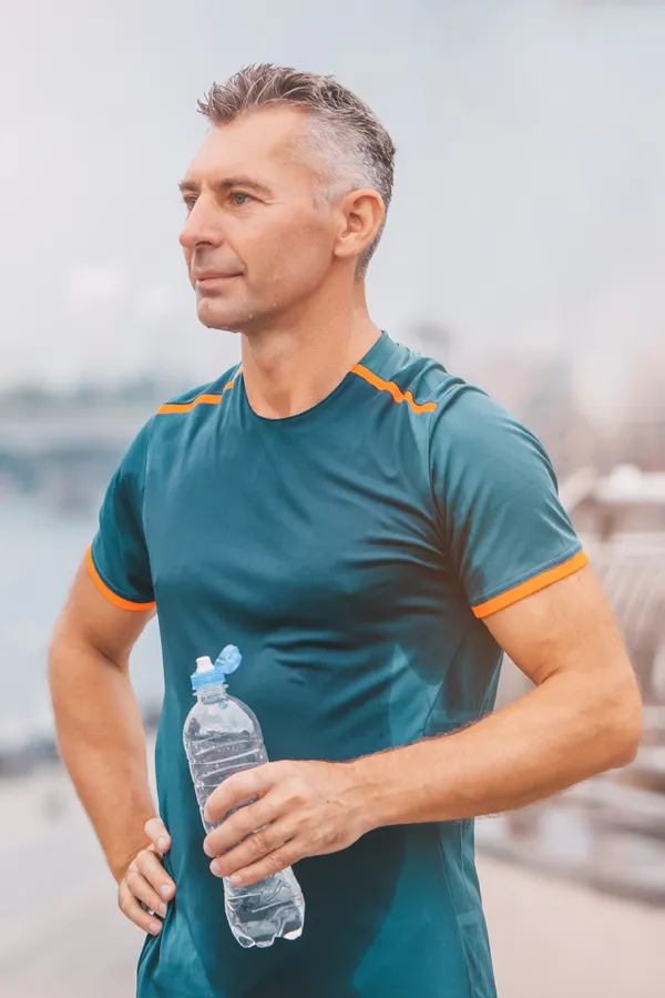 Cardiovascular-Health-Treatment A middle-aged man hydrates after a hard workout. Get cardiovascular health care from Anita Petruzzelli, M.D. in Glastonbury.