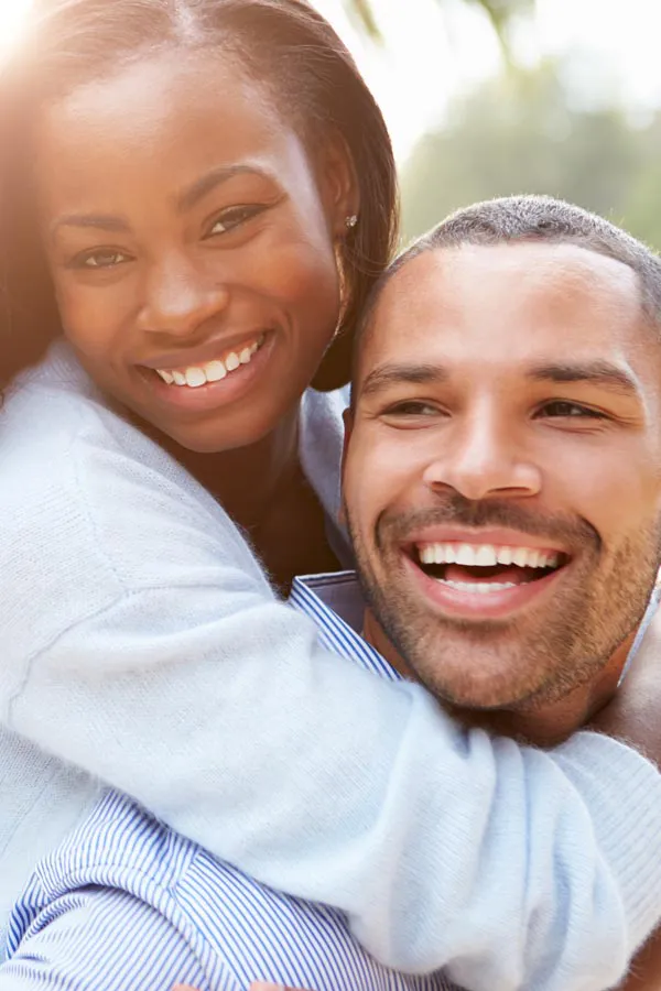Erectile-Dysfunction-Treatment A woman riding on a man's back, both smiling due to help with erectile dysfunction from Anita Petruzzelli, M.D. in Glastonbury.