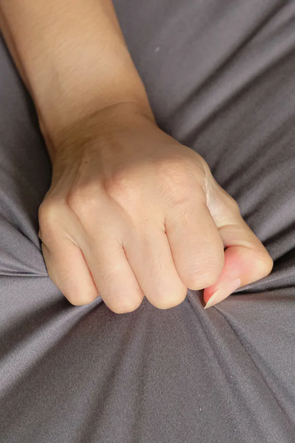 Female-Sexual-Dysfunction-Treatment Close-up of a woman's hand grabbing a sheet, indicating sexual pleasure. Get female sexual dysfunction treatment from Anita Petruzzelli, M.D. in Glastonbury.