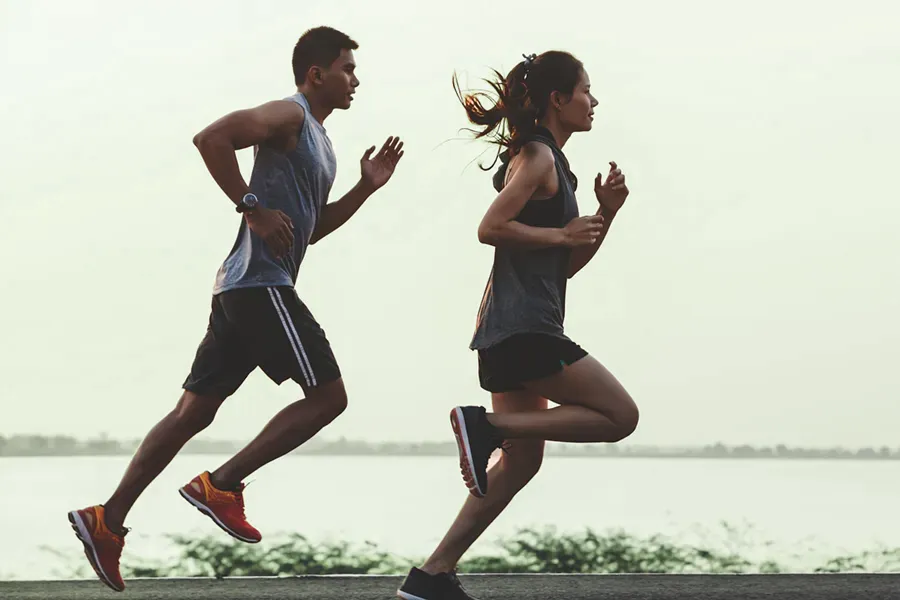 GLP-1-Weight-Loss-Injections-Clinic A couple in profile running along the water. Schedule GLP-1 Weight Loss Injections from Anita Petruzzelli, M.D. in Glastonbury.