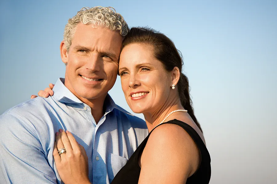 Healthy-Aging-Peptides-Doctor A middle-aged caucasian couple embraces in the sunshine, happy with the healthy aging peptide treatments from Anita Petruzzelli, M.D. in Glastonbury