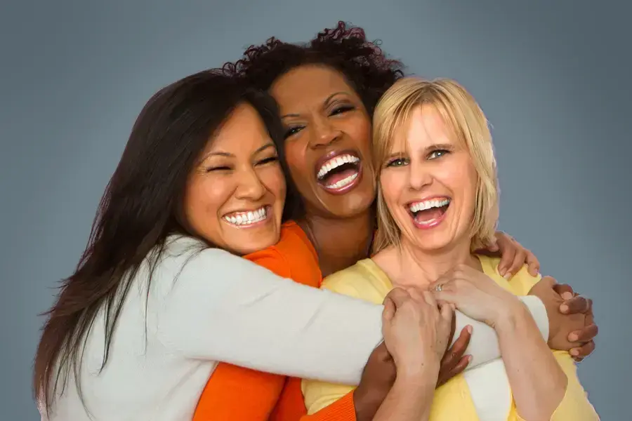 Insulin-Resistance-Clinic An asian, black, and white woman of middle age hug and laugh. Get insulin resistance treatment from Anita Petruzzelli, M.D. in Glastonbury.