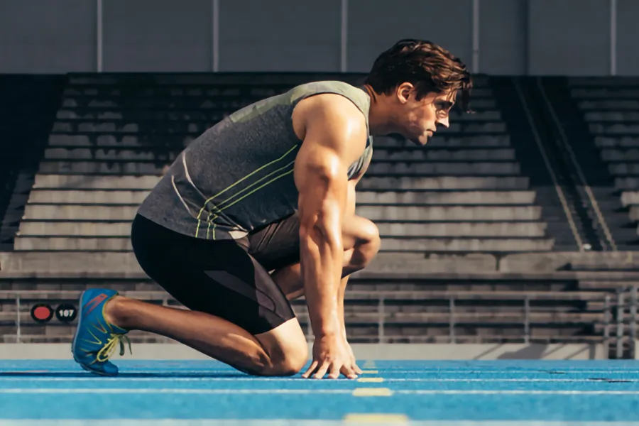 Lean-Muscle-and-Recovery-Clinic A white man kneels at the starting line on a track, determined to do his best. Get treatment for lean muscle loss and recovery from Anita Petruzzelli, M.D. in Glastonbury.