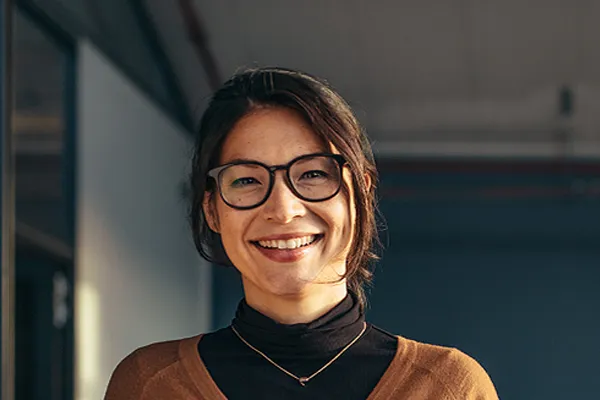 Metabolic-Syndrome-Clinic A brunette woman with glasses smiles in a gray-blue walled office. Get metabolic syndrome from Anita Petruzzelli, M.D. in Glastonbury.