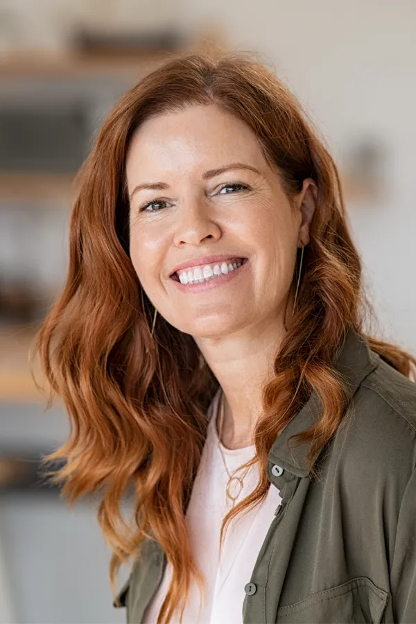 Peptides-for-Hair-Restoration-Treatment A woman with beautiful long red hair smiles due to the success of peptides for hair restoration treatments from Anita Petruzzelli, M.D. in Glastonbury.