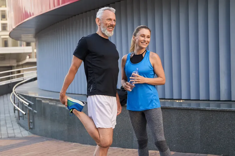 Peptides-for-Healing-and-Recovery-Doctor A middle-aged couple happily stretch and prepare for exercise after receiving effective peptide therapy for healing and recovery from Anita Petruzzelli, M.D. in Glastonbury.