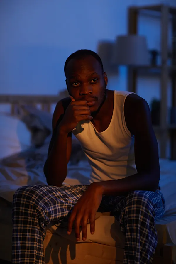Sleep-Disorders-Treatment A man sits on the edge of his bed concerned that he can't sleep. Get treatment for sleep disorders from Anita Petruzzelli, M.D. in Glastonbury.